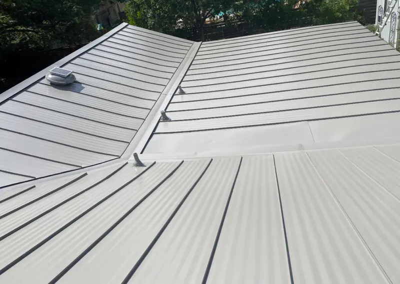 Solar attic fan installed on a metal roof for Roof Ventilation in Fountainebleau